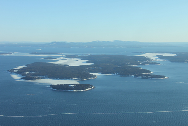Swans Island with Seal Cove and Mackarel Cove frozen over.  Mount Desert is in the distance.